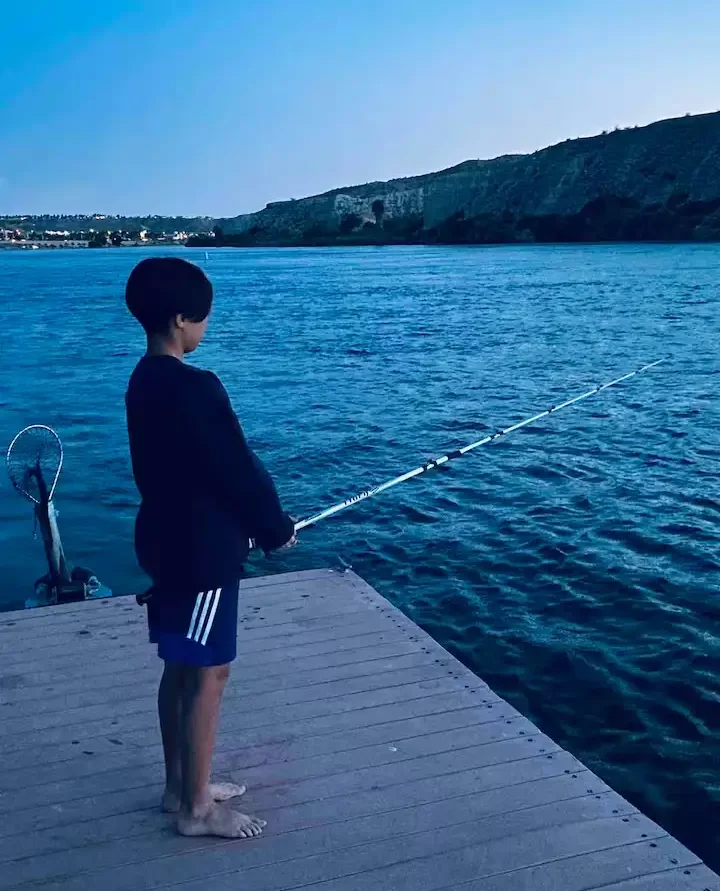 Guest fishing off the private dock at The Haven River Lodge