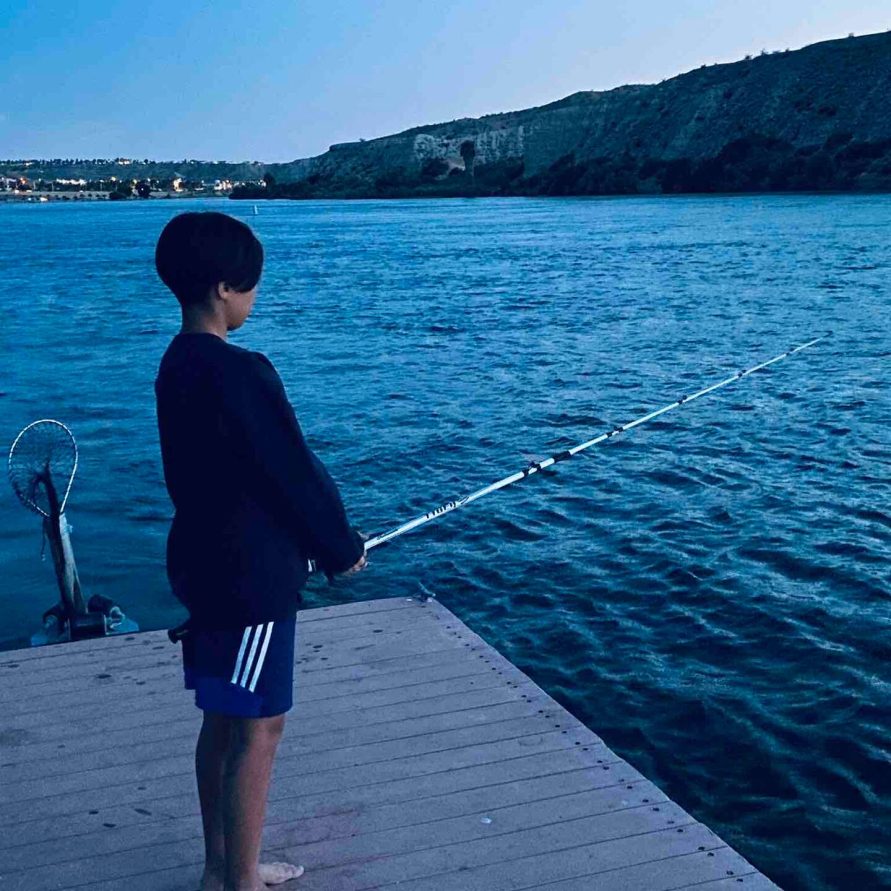 Guest fishing off the private dock at The Haven River Lodge